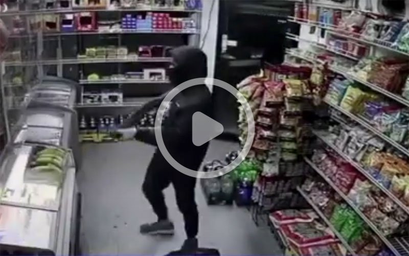 Masked man with shotgun inside convenience store